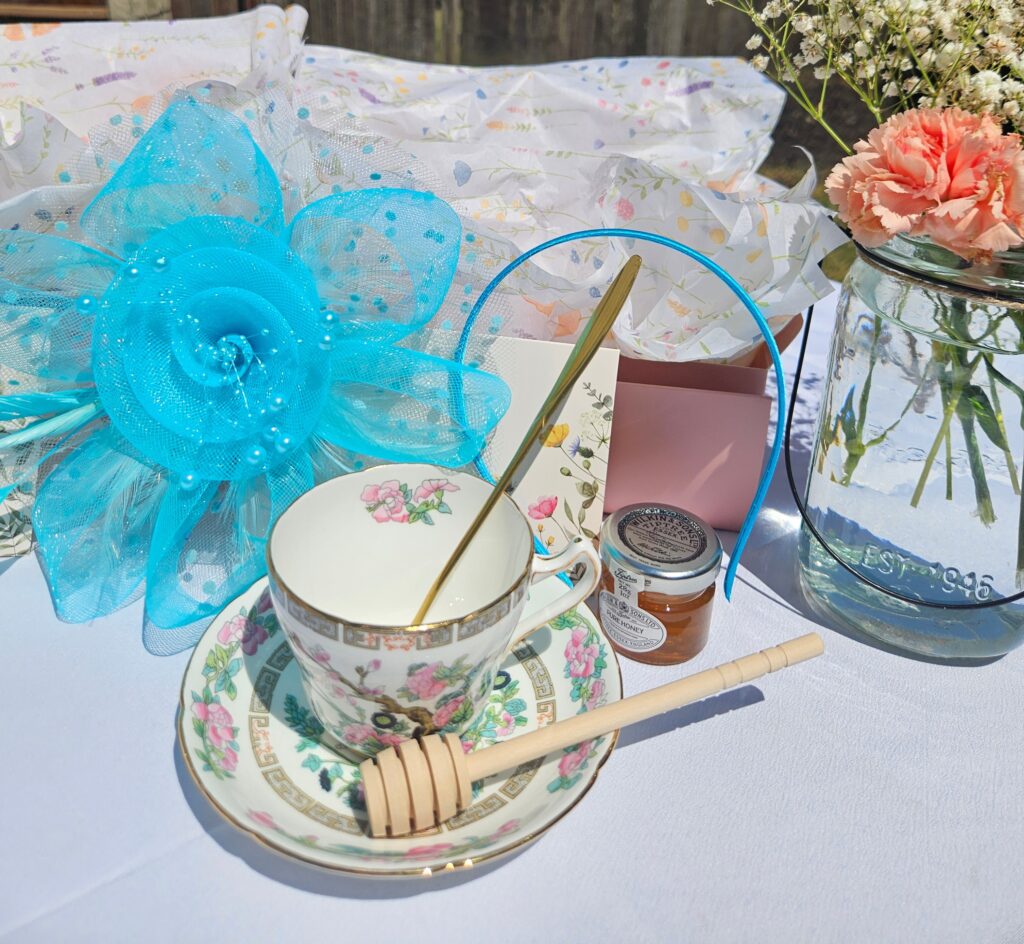 Image of Attainabilitea Tea Box with a blue fascinator.
